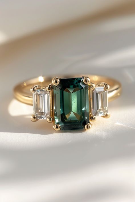 Discover the beauty of green emerald cut sapphire engagement rings and learn how to choose the perfect ring for your special someone. With its captivating color and unique cut, this gemstone will be cherished for a lifetime. Explore our top picks and expert advice on selecting the best quality ring for the most important question of your life. Lab Emerald Engagement Ring, Green Proposal Ring, Wedding Ring Green Emerald, Emerald Green Engagement Rings, Green Emerald Cut Engagement Ring, Engagement Ring Emerald Green, Engagement Rings With Colored Stones, Emerald Green Ring Engagement, Green Sapphire Engagement Rings