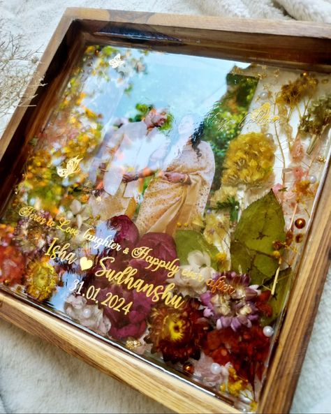 Looking for special gifts for newly weds?? You are in the right place ✨ My dad being a fan of trending teakwood frames asked me , could u create a photo frame as a wedding gift for a couple. And here it is! Crafted this beautiful vibrant yet elegant looking frame for a beautiful couple. And he absolutely loved the frame ❤️ Isn't it a special feeling when our family loves our work & supports us becoming a client ? 💞 Dm to order yours! #weddingframes #weddinginspiration #resinteakwoodframe ... Resin Art For Anniversary, Resin Art Frames For Couple, Varmala Preserve In Resin Photo Frame, Resin Couple Gift Ideas, Wedding Gifts Ideas For Couple, Couple Photo Frame Ideas, Photo Frame Craft Ideas, Gifts For Newly Weds, Wedding Gifts Painting