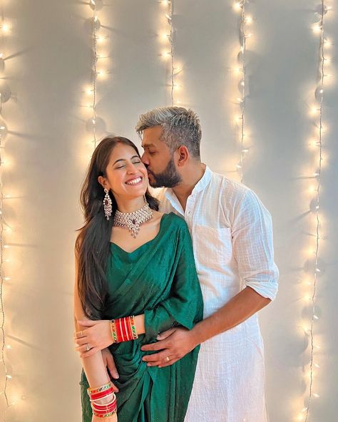 Couple pose idea. Male partner kissing the forehead of his partner and girl smiling with eyes close while facing the camera. Diwali Couple Photography Poses Traditional, Diwali Photo Shoot For Couple, Diwali Pictures Couple, Couple Poses Saree Photography, Diwali Cupal Photo, Diwali Photography Couple, Couple Pose In Saree And Kurta, Couple Poses Diwali, Diwali Photoshoot Ideas Couple