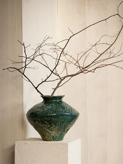 Introduce a touch of rustic charm to your home with our wabi-sabi irregular ceramic vases. Each rustic vase is handmade, featuring a with a dark green glossy glaze. The irregular design and texture of these ceramic pieces bring a distinctive and natural feel to any space, perfect for showcasing your love of organic elements. Versatile and unique, our textured ceramic vases are ideal for indoor plants, soil plants, fresh flowers, or even artificial flowers. Their rustic design easily coordinates Green Ceramic Vase, Japandi Penthouse, Wabi Sabi Color Palette, Wabi Sabi Color, Modern Vases Decor, Textured Vases, Japandi Lamp, Organic Vase, Plant Vases