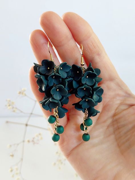 https://purplebeestudio.etsy.com Handmade polymer clay chandelier earrings. These very delicat earrings in classic Royal Emerald Colour will become your favorits for many occasions day or night.  Perfect gift for a special woman in your life. Earrings made with brass ear wire. The earrings are very light and comfortable to wear all day. SHIPPING: Your order will be dispatched in a securely packed cardboard box. Product care:  - To ensure the product quality and durablility, avoid contact with water, lotion, perfumes and household cleaners and chemicals. - You can clean the products with a slightly damp soft fabric.  - Sharp objects can damage the clay surface. - When not in use, store in a dry, seperate box. Thank you for visiting my shop! If you have any special requests, I'll be happy to Polymer Clay Plugs Gauges, Polymer Clay Chandelier Earrings, Floral Wedding Jewelry, Polymer Clay Floral Earrings, Polymer Clay Jewelry Ideas, Clay Chandelier, Polymer Clay Spring, Emerald Bridesmaid, Polymer Clay Flower Earrings