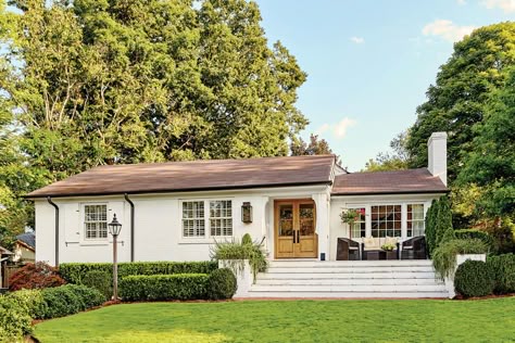 The Front Steps Create Balance - A Dramatic Ranch House Renovation - Southernliving. The 19-foot-wide stairs run all the way to the edge of the house. This design trick fills the void beneath the wide window on the right and creates the feeling of a traditional front porch without altering the ranch's straight roofline. Ranch Renovation, Ranch House Remodel, Exterior House Renovation, Ranch House Exterior, Ranch Remodel, Ranch Exterior, Brick Ranch, Exterior Renovation, Exterior Paint Color