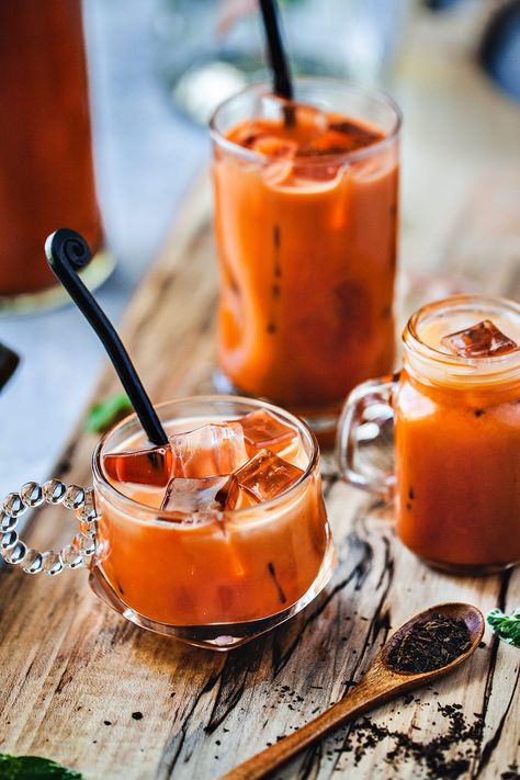 Learn how to make authentic Thai iced tea (Cha Yen) in two easy methods. Then indulge in the sweet, creamy, rich, and refreshing drink. It's the perfect drink to sip on all year round! #thaiicedtea #thaitea #chayen #thaitearecipe #howtomakethaitea #easythaiiced tearecipe #thaiicedtearecipe Thai Tea Recipes, Thai Iced Tea, Yummy Summer Drinks, Iced Tea Recipes, Thai Dessert, Thai Tea, Drink Photography, Iced Drinks, Fresh Juice