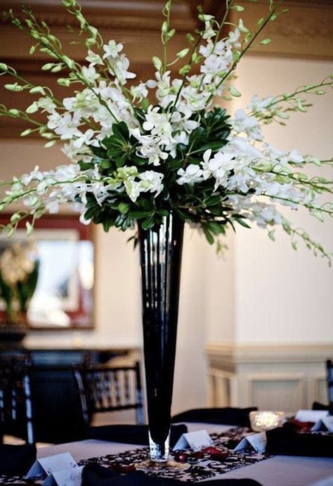 A simple but elegant vase, our tall black glass trumpet vase is an excellent choice for any gathering. It is the perfect vase for floral displays and wedding centerpieces. Tapered from the top all the way down to its strong footed base allows for support of large and heavy floral arrangements. Tall Vase Wedding Centerpieces, Cheap Wedding Table Centerpieces, Orchid Centerpieces, Tall Wedding Centerpieces, Easy Wedding, Unique Wedding Flowers, Wedding Floral Centerpieces, Tall Centerpieces, Tall Vase