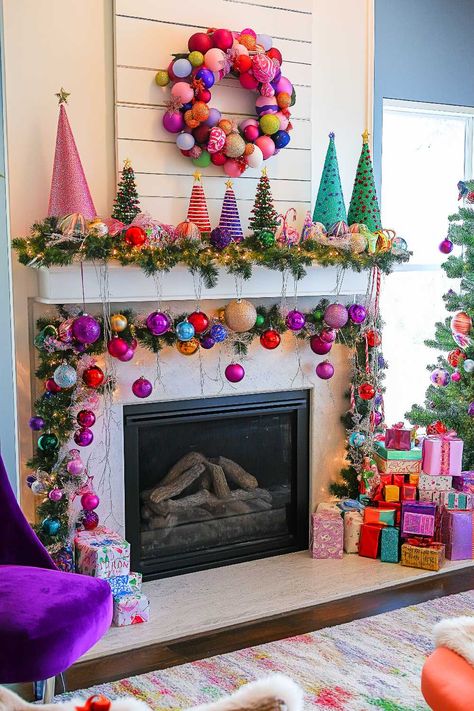 25+ Christmas Mantle Decor Inspirations for a Contemporary Holiday Pool Noodle Christmas Mantle, Holiday Garland Ideas, How To Decorate A Fireplace, Christmas Garland Ideas For Mantle, Colorful Christmas Mantle, Fireplace Mantle Christmas Decor Ideas, Summer Fireplace Decor, Xmas Garland Ideas, Christmas Mantle Decor Ideas