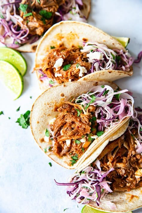 These tacos are filled with mouthwatering slow cooker pulled pork and creamy cilantro lime slaw. Easy, effortless and delicious! Pulled Pork Tacos Sauce, Pulled Pork Recipes Healthy, Taco Pulled Pork, Pork Taco Slaw, Sauce For Pulled Pork Tacos, Slow Cooker Pulled Chicken Tacos, Pulled Pork Healthy Recipes, Sauce For Pork Tacos, Taco Slow Cooker Recipes