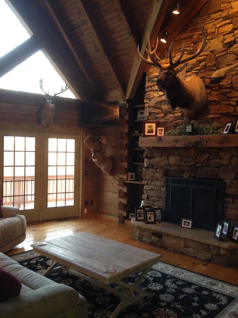 Rustic living room. Hunting trophies. Elk mount. Log cabin living room Elk Above Fireplace, Moose Mount Living Room, Hunting Camp Ideas Cabin Living Room, Deer On Wall Living Room, Deer Head In Living Room, Hunting Cabin Aesthetic, Deer Cabin Decor, Taxidermy Living Room, Elk Mount Living Room