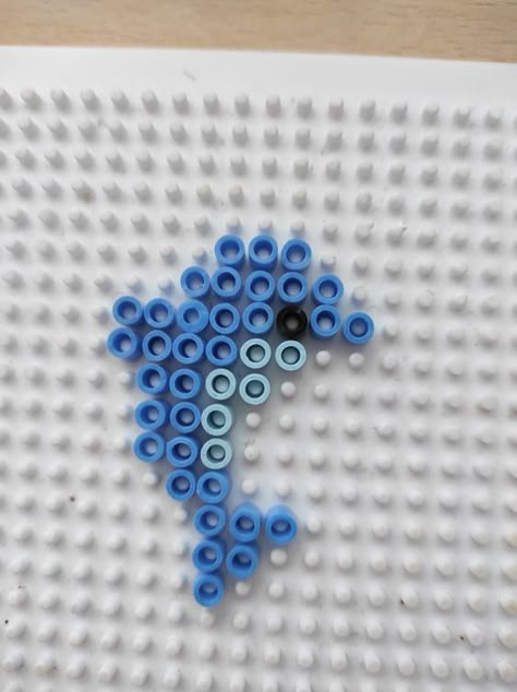 Delfinek z kolarów Hama ❤️‍🩹 #BeadingPatterns #PerlerBeadPatterns #FuseBeadPatterns Bead Art Ideas Cute, Pear Beads Ideas, Ironing Bead Ideas, Grimace Perler Beads, Puller Beads Ideas, Aqua Bead Designs, Melting Beads Patterns Easy, Cute Pearler Beads Ideas Easy, Easy Fuse Bead Patterns