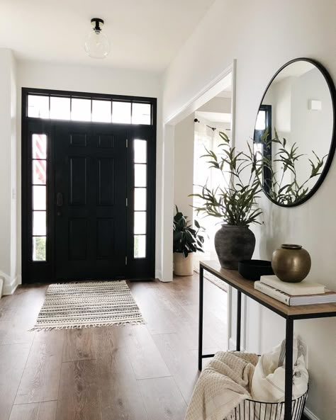 Black Entry Way Door Inside, Black Interior Front Door With Transom, Black And White Home With Wood Accents, Front Entry Door Black, Black White And Wood Hallway, Front Door Lighting Interior, Foyer Black Door, Entryway Black Mirror, White Black Wood Decor