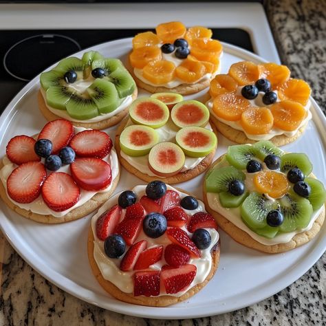 🍪🍓 Turn snack time into a colorful treat with Fruit Pizza Cookies! Bursting with fresh flavors. #SnackAttack #FruitPizzaCookies Fruit Pizza Cookies Recipe 🎨 Ingredients: Cookie Base: 150g granulated sugar 115g unsalted butter, softened 1 egg 5ml vanilla extract 190g all-purpose flour 3g baking powder 1g salt Topping: 200g cream cheese, softened 30g powdered sugar 5ml lemon juice Fresh fruits (strawberries, kiwi, blueberries, grapes), sliced Instructions: Cookie Base: Preheat oven to 175°C... Thanksgiving Fruit Pizza, Fruit Pizza Cookie Recipe, Fruit Pizza Cookie, Sugar Cookie Fruit Pizza, Fruit Pizza Cookies, Fruit Cookie, Pizza Cookie, Fruit Pizzas, Pizza Cookies