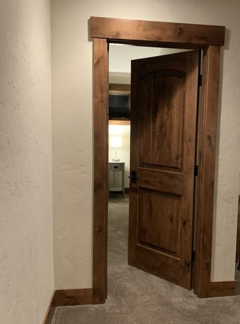 Wood Doors Black Trim, Wood Doors Wood Trim, Dark Trim Interior Baseboards, Barnwood Trim Interior, Wood Doors And Trim Interior, Dark Walnut Front Door, Dark Wood Interior Doors, Dark Wood Baseboards And Trim, Farmhouse Trim Doorway