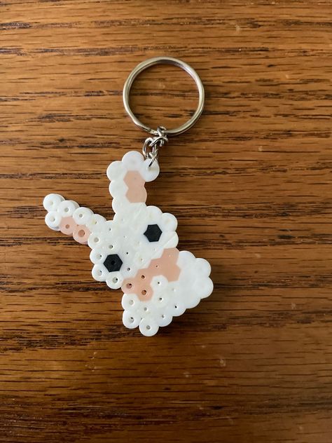 This was made from fuse beads and a keychain Fuse Beads Ideas Cute And Easy, Fuse Bead Keychains, Iron Beads Keychain, Perler Beads Flower Pattern, Peeler Bead Keychain, Cute Fuse Beads Ideas, Bunny Perler Beads, Perler Bead Cow, Small Hama Bead Designs