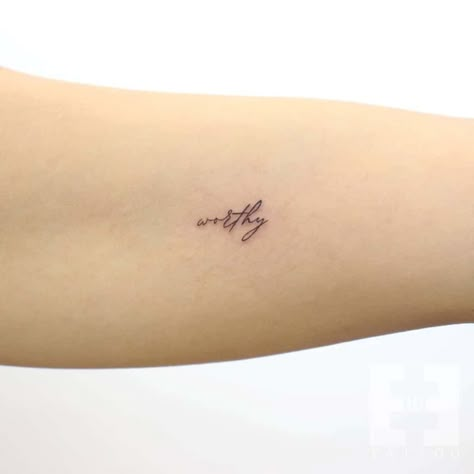 Self Priority Tattoo, Work In Progress Tattoo Words, Unique Word Tattoos Inspiration, Micro Word Tattoo, Short Word Tattoos For Women, Floral Word Tattoo, Tattoos About Being Enough, Loved Tattoo Word, Strength Word Tattoo