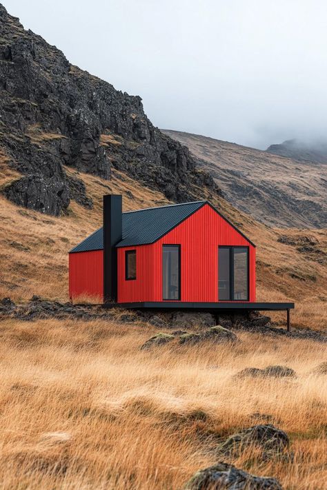 Red cabin nestled against rocky hillside under a gray sky. Little cabins with less space can equal more joy, laughter, and maybe even a whole new perspective on what “downsizing” truly means. Tiny House On Hillside, Mini Home Design, Easdale Island, Mini Cabin Ideas, Concrete Cabin, Tiny Houses Ideas, Red Cabin, Tiny Container House, Studio Cabin