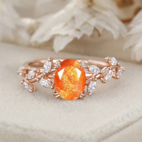 Our Handcrafted Oval Cut Sunstone Engagement Ring features a Nature-Inspired Branch Cluster in Solid Gold. The oval-cut sunstone and the cluster design create a ring that is both artistic and romantically inspired by the beauty of the natural world." Sunstone Ring Engagement, Orange Engagement Ring, Sunstone Engagement Ring, Cluster Design, Cute Engagement Rings, Couple Wedding Rings, Colored Engagement Rings, Moonstone Engagement Ring, Solid Gold Ring