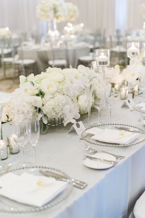 Pure White Wedding Decor, White And Grey Wedding Flowers, White Cream Ivory Wedding, Wedding Place Setting Silver, White Grey Wedding Decor, Silver Grey And White Wedding Theme, White Low Centerpiece Wedding, White And Silver Table Settings, White Wedding Set Up