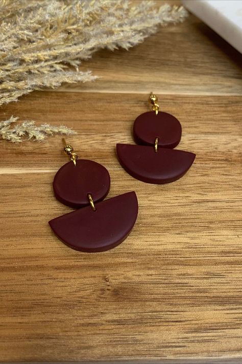 These maroon polymer clay half moon and circle earrings will be your new go-to earrings for fall and winter. The mixed shapes and modern geometric style make these beautiful maroon clay earrings perfect for any occasion - dress up or wear with a casual look. Lightweight and durable. Handmade from polymer clay. Fall Color Clay Earrings, Maroon Polymer Clay Recipe, Handmade Brown Polymer Clay Jewelry, Brown Polymer Clay Earrings, Maroon Polymer Clay Earrings, Maroon Clay Earrings, Circle Earrings, Diy Earrings, Polymer Clay Jewelry