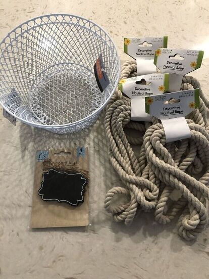 I think I have become addicted to Dollar Tree DIY’s. I was in my local Dollar Tree store recently and found some nautical rope. It’s nice quality, so naturally I grabbed 5 of them! Then I was like, hmmmm……ok, what the heck am I going to do with this. As I continued walking around the store, I found some small wire baskets, and some mini chalkboard signs, and the idea to try my hand at making a DIY Dollar Tree Rope Basket came into my head. Here is how I did it…   Here are the supplies… Rope Storage Basket Diy, Diy Kitchen Utensil Holder, Mini Chalkboard Signs, Dollar Tree Baskets, Tree Rope, Diy Rope Basket, Mini Chalkboards, Rope Baskets, Basket Crafts