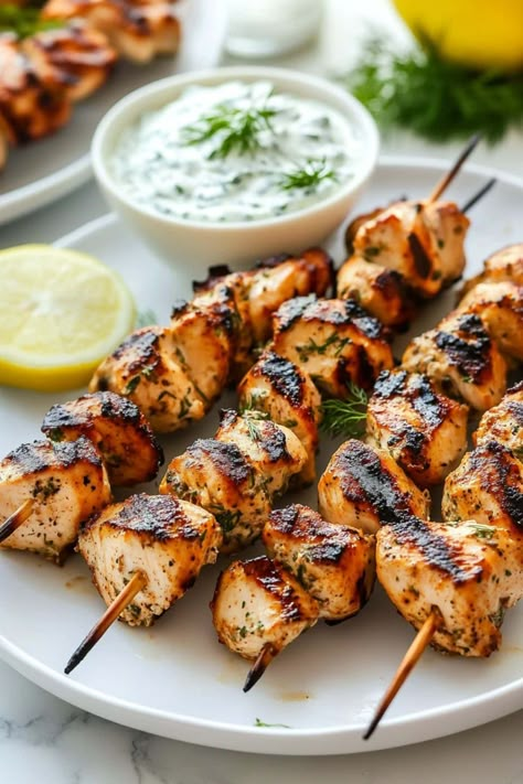 Greek chicken souvlaki with tzatziki brings the vibrant flavors of the Mediterranean right to your table. It's savory, zesty, and oh-so-juicy. Cook Chicken In Oven, Greek Chicken Skewers, Grill Foods, Greek Chicken Souvlaki, Souvlaki Recipe, Chicken Entree, Easy Chicken Marinade, Family Meal Recipes, Cooking Panda