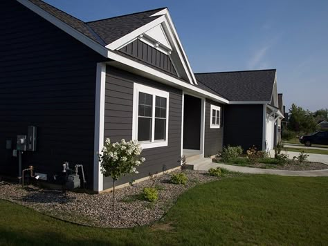 Dark Gray Siding With White Trim | Exterior Color Selections Dark Grey House Exterior, Dark Gray House Exterior, Grey House White Trim, Vertical Siding Exterior, Dark Grey Siding, Dark Grey Houses, Grey Exterior House Colors, Grey Siding, Gray House Exterior