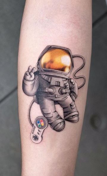 200 Unique New School Tattoos, Designs, & Ideas - Tattoo Me Now Astraunaut Tattoo, Hologram Tattoo, Spaceman Tattoo, Astronaut Tattoos, Gold Tattoos, Tattoo Space, James Webb Telescope, Spiderman Tattoo, Webb Telescope