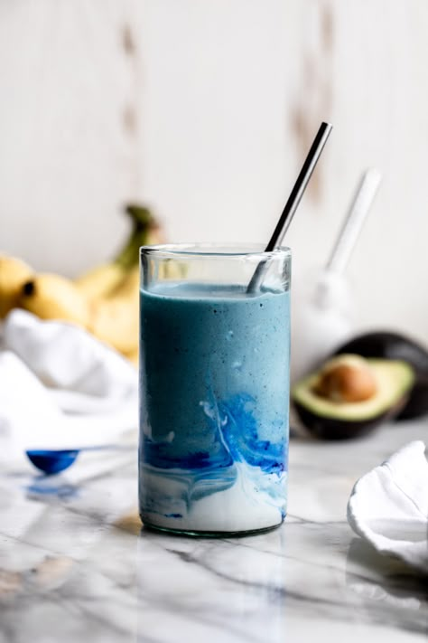 blue smoothie in a glass with coconut cream swirl and straw with banana and avocado in background Coconut Cloud Smoothie, Smoothie Inspiration, Cloud Smoothie, Smoothie With Coconut, Coconut Cloud, Blue Smoothie, Banana Drinks, Yummy Meals, Organic Fruits And Vegetables