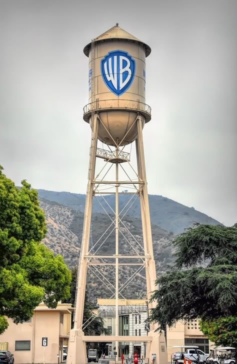 The Warner Bros. Water Tower is a historic water tower located at the Warner Bros. lot in Burbank. Built in 1927, it stands 133 feet tall. The tank has a capacity of 100,000 gallons but it now serves as a company icon. Warner Brothers Logo, Animaniacs Characters, Warner Bros Logo, Galaxy Planets, Warner Bros Studios, Movie Studios, Los Angeles Travel, Warner Brothers, Water Tower