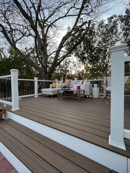 "My family and I enjoy spending our weekend evenings on the deck. It’s a great space to take in the sunset, listen to music, and relax after a long week. It gives us a dedicated space for our cherished family time," shares Trex homeowner, Ashley. Scroll to see the charming outdoor space she built with her friend, Charlee of Build & Create Home, using the Trex “Deck in a Box” Kit. Picture Frame Deck Design, Front Deck Ideas, Trex Deck Ideas, Trex Patio, Trex Deck Colors, Trex Colors, Gray Deck, Trek Deck, Trex Decking