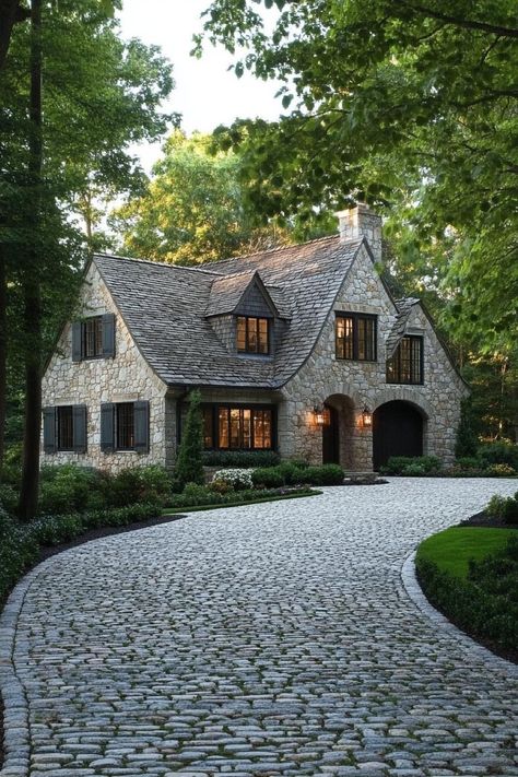 Modern English cottage front yard with cobblestone driveway lined with trees. Check out all of these modern English cottages that are as charming as they are functional. Can this be your dream home? English Country House Exterior Modern, Old Looking Houses, Brick Stone Wood House Exterior, Stone Tudor Cottage, Tudor Country House, Building On Land, Cottage Style Ranch Homes Exterior, Cottage Style Ranch Homes, Large Cottage Exterior