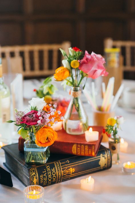 Short #reception #centerpiece with books as flower vase stand - babb photo Book Wedding Centerpieces, Historic Library, Flowers In Vases, Unique Wedding Centerpieces, Book Centerpieces, Jenny Smith, Book Themed Wedding, Literary Wedding, Colorful Centerpieces