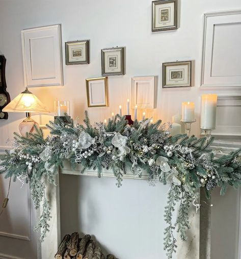 Christmas Mantle Swag Garlands, White Garland Christmas Decor, Christmas Mantelpiece Ideas, Country Christmas Fireplace Decor, Door Frame Christmas Decorations, Garland Over Fireplace, White Fireplace Christmas Decor, Xmas Mantle Decorations, Flocked Garland Mantle