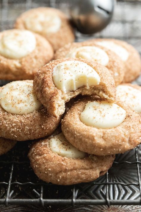 A soft cookie filled with eggnog ganache (with rum!) these Eggnog Snickerdoodle Thumbprint Cookies are a true taste of Christmas! #eggnogcookies #eggnogthumbprintcookies #eggnogsnickerdoodles Eggnog Snickerdoodle Thumbprint Cookies, Holiday Bakes Goods, Snickerdoodle Eggnog Cookies, Egg Nog Snickerdoodle Cookies, Peanutbutter Christmas Cookies, Eggnog Snickerdoodles Recipe, Egg Nog Thumbprint Cookies, Egg Nog Snickerdoodles, Christmas Cookies To Freeze Ahead