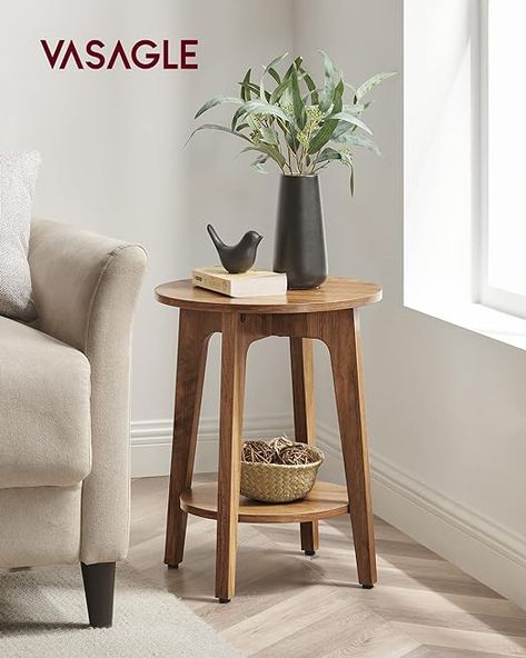 Modern Farmhouse Vibe: The round tabletop, rustic walnut finish, and angled legs merge on this small side table, adding a cozy, comfortable modern farmhouse vibe to your living space 2-Tier Storage: The tabletop is spacious to place an elegant flower vase, a cup of coffee, or a stack of books, and the lower shelf is perfect to display your mementos Round Side Table Decor, Nancy Meyers Style, Side Table Decor Living Room, Shelf End Table, Small Round Side Table, Podcast Setup, Living Room Items, Round Wood Side Table, Unique Side Table