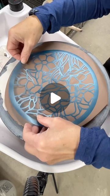 Christine Stangel on Instagram: "There she goes again! Something old mixed with something new!  Taking my traditional painted floral pottery line to a new level with the magic of technology. All summer and fall I have been learning the ins and outs of Photoshop along with my new Cricut Maker to create my own stencil designs. This gives me the ability to have more intricate details when painting flowers. Such a huge learning curve, but oh the possibilities! These trivets will be available this December! @wintercraftmarket #csstangelpottery" Pottery Tiles Ideas Design, Pottery Painting Ideas Guys, China Painting Ideas, Pottery Display Ideas Home, Scraphito Ceramic, Stencil Ceramics, Stencil Pottery, Cricut Pottery, Clay Tiles Designs