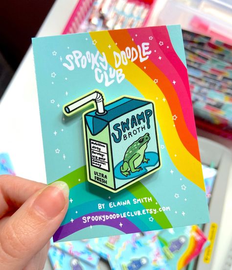 Spooky Doodle Club acrylic pin featuring a swamp broth juicebox. Perfect for fans of spooky and cute things! #spookydoodleclub #spooky #cute #pin . #Juice_Box_Art #Winona_Mn #Cosplay_Wings #Frog_Gifts Enamel Pin Design, Juice Box, Acrylic Pins, Spooky Cute, Pin Design, Cute Doodle Art, Poster Stickers, Cool Stickers, Cute Pins