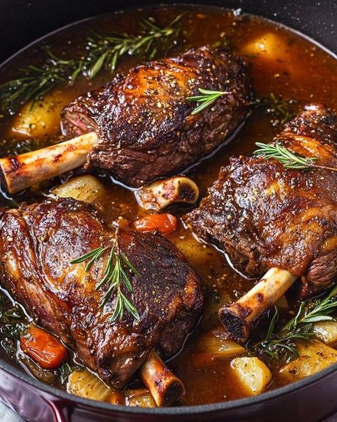 Tender Slow-Cooked Lamb Shanks simmered in a rich, herb-infused gravy for a comforting, flavorful meal perfect for cozy dinners. Braised Lamb Shanks, Braised Lamb, Lamb Shanks, Homemade Recipe, Onions, Garlic Cloves, Homemade Recipes, Olive Oil, Garlic