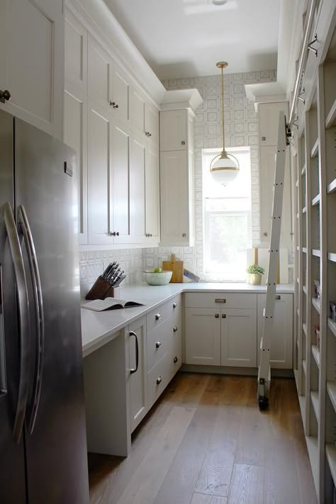 Well appointed walk-in pantry is equipped with a stainless steel refrigerator recessed beneath light gray cabinets painted in Benjamin Moore Edgecomb Gray and accented with Armac Martin Queslett Hardware. Benjamin Moore Edgecomb Gray, Beautiful Pantry, Modern Country Kitchens, Pantry Layout, Pantry Inspiration, Edgecomb Gray, House Pantry, Light Gray Cabinets, Pantry Laundry Room