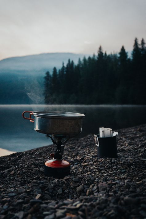 Boiling water on a MSR backpacking stove with a pour over coffee in a cup on a rocky beach in the mountains. Coffee Setup, Outdoorsy Aesthetic, Mountain Lifestyle, Coffee Shot, Mountain Coffee, Earth Photos, Product Photography Ideas, Sing A Song, Nature Hiking