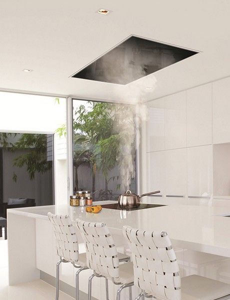 The recessed kitchen vent: Siemens ceiling hood | Corian model kitchen | Remodelista Vent Hood Over Island With Pendant Lights, Island Exhaust Hood, Modern Kitchen Range Hood, Kitchen Vents, Kitchen Island Range, Modern Refrigerator, Miele Kitchen, Island With Stove, Ceiling Hood