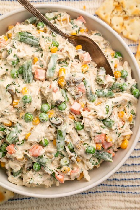 Mexican chicken salad is tender shredded chicken tossed in a creamy sauce with mixed veggies, fresh cilantro, and jalapeños… Tons of flavor! One of my favorites from my time in Texas and California, this is a great dish to serve at any potluck, cookout, or BBQ and will be gone in no time. Delicious on tostadas, with saltines for dipping, as a sandwich, or even eaten straight with a fork! Shredded Chicken Salad, Cold Chicken Salads, Mexican Chicken Salad, Shredded Chicken Salads, Mexican Chicken Salads, Tender Shredded Chicken, 40 Aprons, Tostada Recipes, Keto Chicken Salad