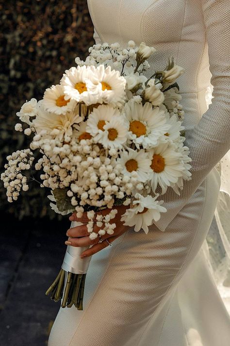 A daisy bridal bouquet with baby’s breath accents. Daisy Flower Wedding Decor, Neutral Colored Flowers, Baby Breathe Weddings, Bouquet Of Flowers Wedding Rustic, Daisy Wildflower Bouquet, Daisies And Baby Breath, Simple Summer Bouquet Wedding, Baby Breaths Bouquet, Mexico Wedding Bouquet