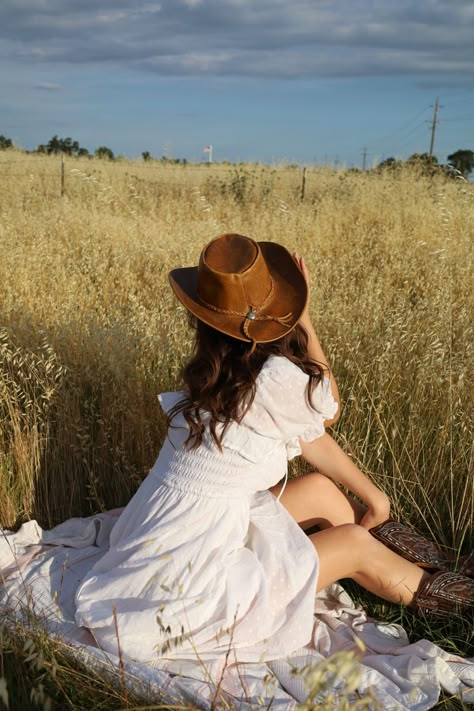 Dress Cowgirl Boots Outfits, Soft Cowgirl Outfit, White Dress Cowgirl, White Dress Cowboy Boots Outfit, Country Sundress With Boots, Western Picnic Photoshoot, Cowgirl Sundress, Country Flower Photoshoot, White Dress And Cowboy Boots