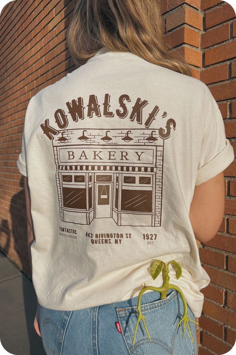 Cozy up in our BAKERY crewneck sweatshirt. This soft, oversized sweatshirt is perfect for lounging around or running errands. #bakery #sweatshirt . #Hippies #Cute_Work_Shirts_With_Logo #Concert_T-shirt_Design #T_Shirt_Font_Design Cute Work Shirts With Logo, Logo Tshirt Outfits, Restaurant Tee Shirt Design, T Shirt Font Design, Bakery T Shirt Design, Business T Shirt Design, Cafe T Shirt Design, Work T Shirt Design Ideas, Restaurant Tshirt Designs