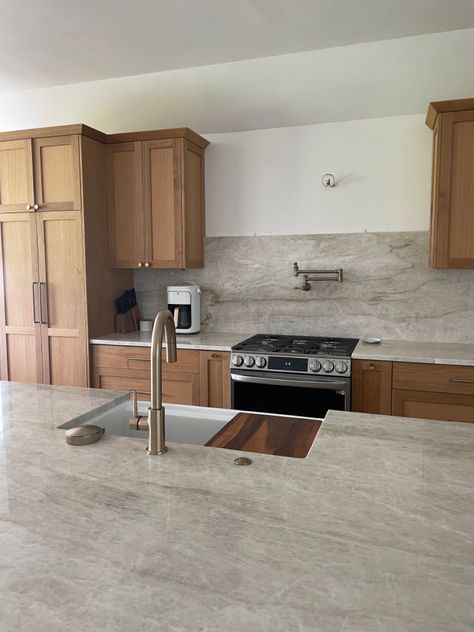 Wood Cabinets With Grey Countertops, White Brown Countertops, Quartz Countertops With Light Wood Cabinets, Cherry Oak Cabinets Kitchen, Uneven Kitchen Cabinets, Quartz Countertops With Maple Cabinets, Leather Quartzite Countertops, Kitchen With Taj Mahal Countertops, Tan Mahal Countertop