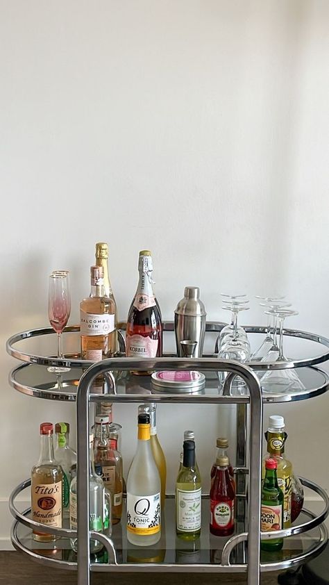 Drink Cart Aesthetic, Living Room Bar Ideas Apartments, House Bar Aesthetic, Bar Cart In Living Room Ideas, Aesthetic Home Bar, Aesthetic Bar Stools, Vintage Bar Cart Aesthetic, Silver Apartment Decor, Cocktail Cart Ideas