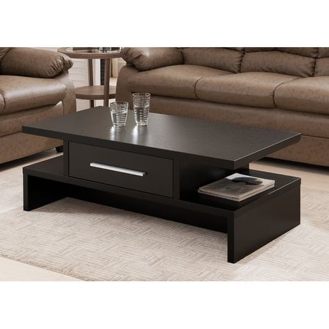 Center your well-appointed living room or den seating group in simple style with this essential coffee table, the perfect balance of clean-lined, loft-worthy looks and effortless utility in your ensemble. Defined by a simple manufactured wood design with classic woodgrain details, this piece offers a neutral touch to your look, while its open side shelves, wide drawers, and metal bar pull add a dash of definition and contemporary appeal to the space. Top it off with a spread of glossy fashion ma Wooden Coffee Table Designs, Centre Table Design, Meja Sofa, Centre Table Living Room, Sofa Table Design, Drawer Coffee Table, Tea Table Design, Table Design Modern, Center Table Living Room