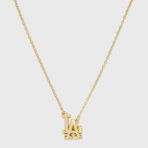 Elevate your game day style with the Bijoux Sport by Luv Aj MLB Logo Charm Necklace. Regardless of which team you’re rooting for, we’ve got the perfect pieces to help you show off your team spirit. This necklace features a sleek charm crafted from high-quality gold-plated brass, ensuring durability and a polished metal finish. The necklace is adorned with an eye-catching logo charm of your favorite MLB team. High quality but also affordable, these pieces are built to endure much more than a nine Classic Gold Necklace With Logo Charm, Gold Pendant Chain Necklace With Logo Charm, Gold Necklace With Logo Charm, Jewelry Stacking Necklaces, Elegant Gold-tone Necklace With Logo Charm, Luxury 14k Gold Tarnish-resistant Charm Necklace, Fancy Accessories, Luv Aj, Initial Pendant Necklace