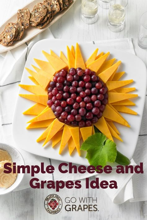 Grapes and cheese, whether on a platter, tray, or board, are the perfect combination for a simple, crowd-pleasing appetizer.  Try this sunflower arrangement with a variety of cheese and red, green, and black grapes from California. #grapes #cheese #simplerecipes #easyrecipes #entertainingideas #partyideas #winetastingideas #appetizerideas #cheeseplatter #cheesetray #cheeseboard Sunflower Fruit Display, Cheese And Fruit Tray Ideas, Sunflower Cheese Platter, Sunflower Cheese Tray, Sunflower Veggie Tray, Bee Fruit Platter, Sunflower Fruit Tray, Sunflower Charcuterie Board, Sunflower Charcuterie