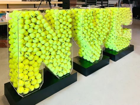 Freestanding NYC 3 dimensional letters full of tennis balls. The letters on this event sign are made of durable acrylic and the base is made of high-quality aluminum. Sports Activation Ideas, Tennis Activation, Ball Display, Logo Signage, Tennis Event, Tennis Party, Sign Boards, 3d Signs, Sports Event