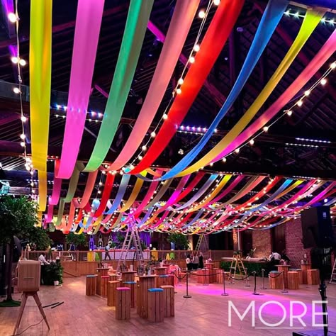 Carnival Lights Decoration, Streamers Across Ceiling, Colorful Event Design, Ceiling Party Decor Ideas, Cool Things To Hang From The Ceiling, Ceiling Streamers Ideas, Streamer Ceiling Decorations, Ceiling Event Decor, Streamers Decorations Ceiling